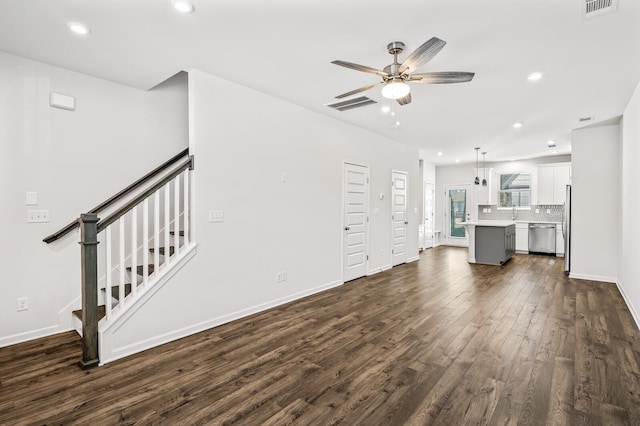 unfurnished living room featuring stairway, dark wood finished floors, visible vents, and recessed lighting