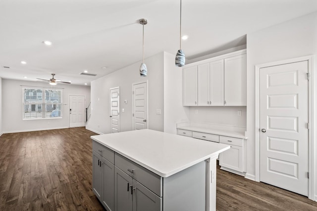 kitchen featuring a kitchen island, white cabinetry, dark wood finished floors, and gray cabinetry