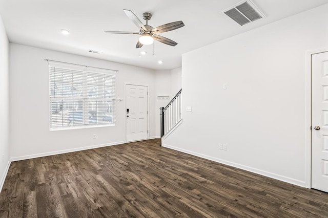 interior space with baseboards, stairs, visible vents, and dark wood-style flooring