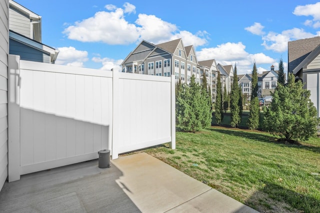 view of yard with a residential view, a patio area, and fence