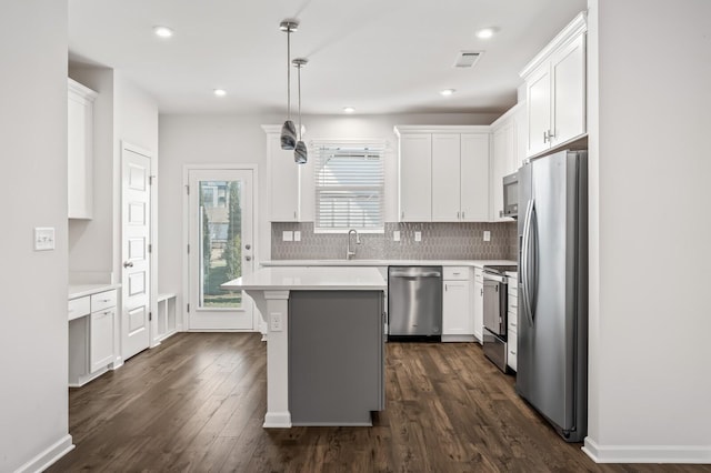 kitchen with a sink, white cabinetry, stainless steel appliances, and light countertops