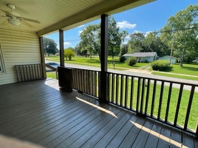 deck with a yard and ceiling fan