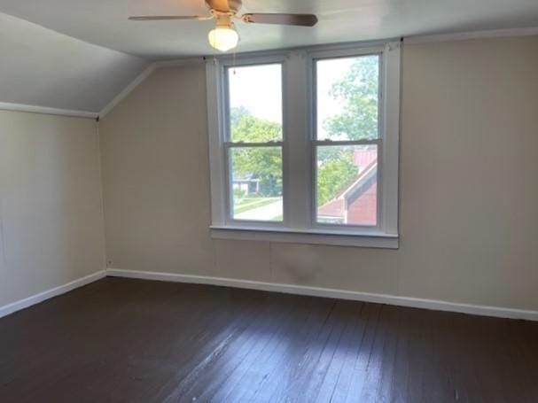 bonus room with vaulted ceiling, wood-type flooring, a ceiling fan, and baseboards