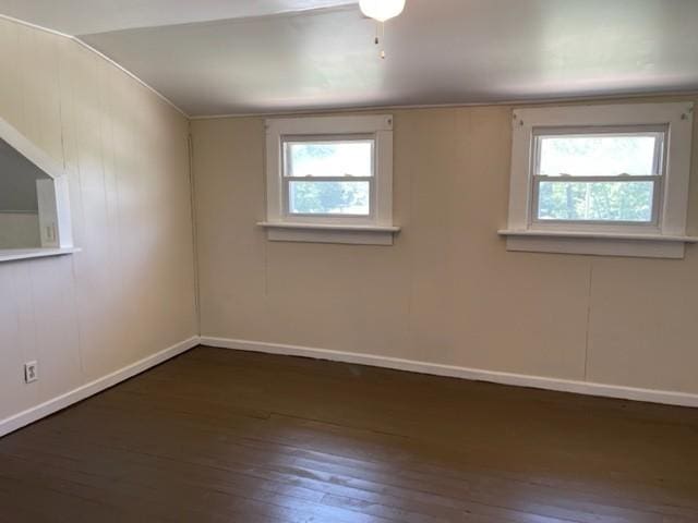 unfurnished room with wood-type flooring, plenty of natural light, and baseboards