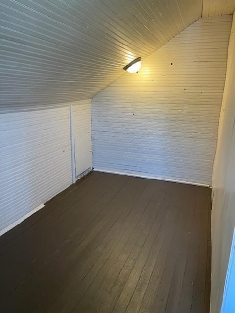 bonus room with dark wood-style floors and lofted ceiling