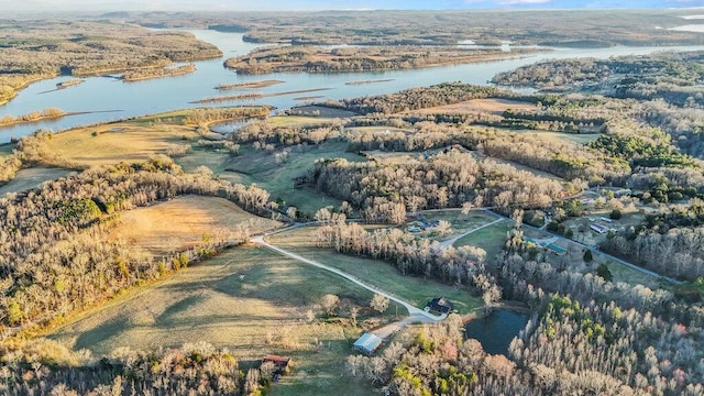 aerial view with a water view and a wooded view