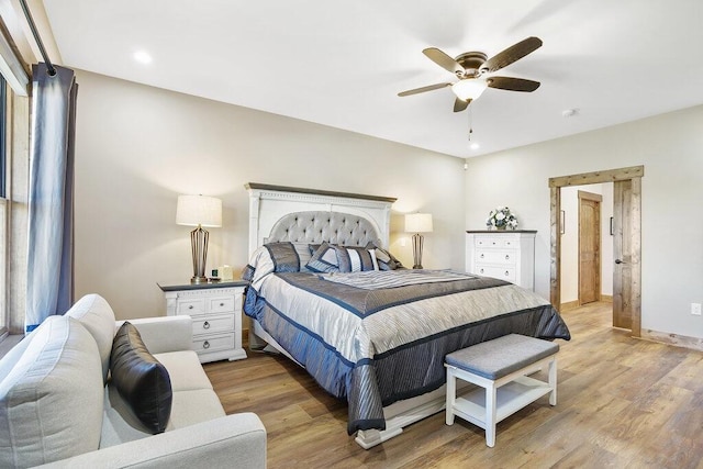 bedroom featuring light wood finished floors, baseboards, and a ceiling fan