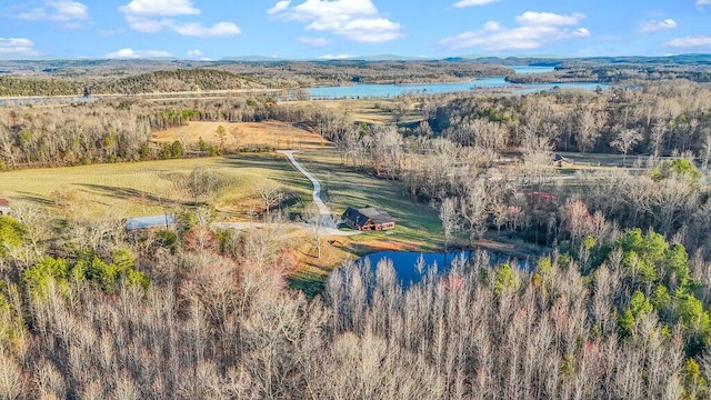 drone / aerial view featuring a water view and a forest view