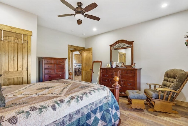 bedroom with ceiling fan, wood finished floors, and recessed lighting