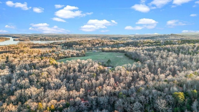 drone / aerial view featuring a water view and a wooded view