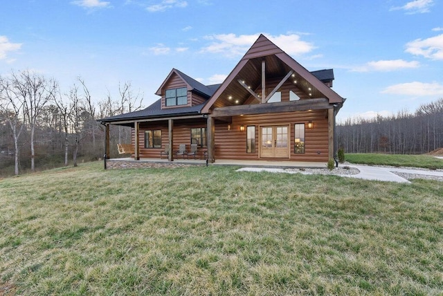 view of front of property with a front yard and french doors