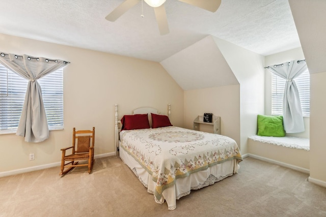 bedroom with light colored carpet, vaulted ceiling, a textured ceiling, and baseboards