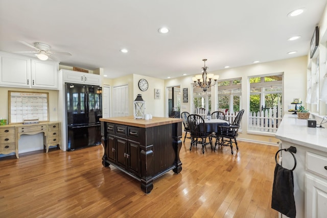 kitchen with recessed lighting, wood counters, white cabinetry, light wood-type flooring, and freestanding refrigerator