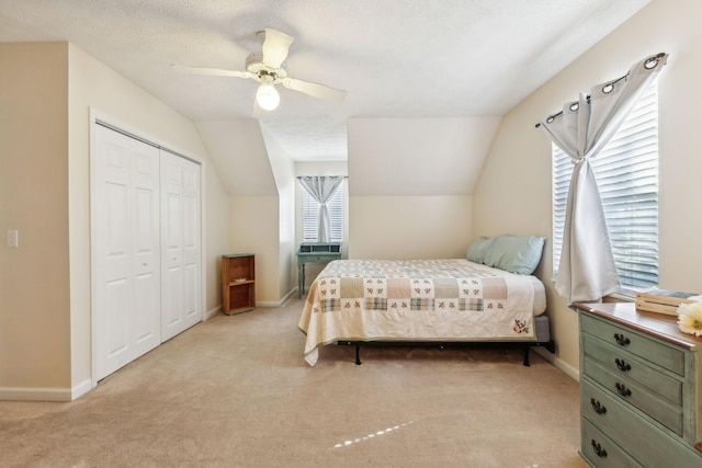 bedroom with carpet floors, lofted ceiling, and baseboards