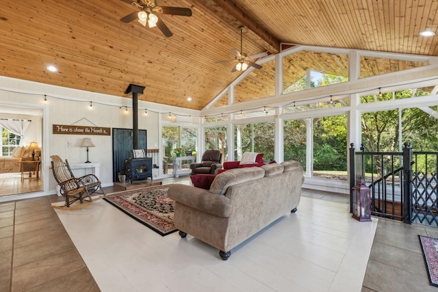 living room with a wood stove, wood ceiling, high vaulted ceiling, and beam ceiling