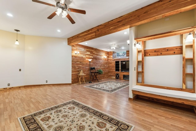 interior space featuring wood walls, recessed lighting, wood finished floors, and beamed ceiling