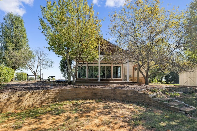 rear view of property with a shed and an outbuilding