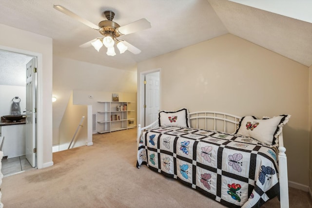 carpeted bedroom featuring lofted ceiling, ceiling fan, a textured ceiling, and baseboards