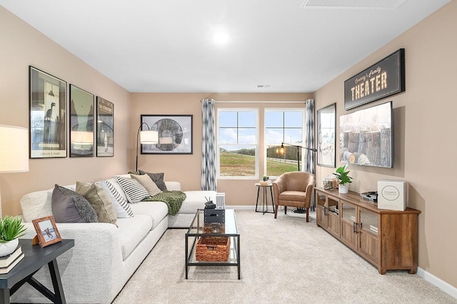 living room with baseboards and light colored carpet