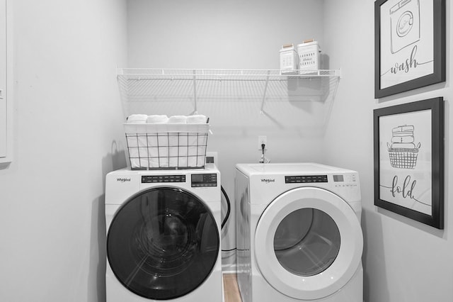 laundry area featuring laundry area, independent washer and dryer, and wood finished floors