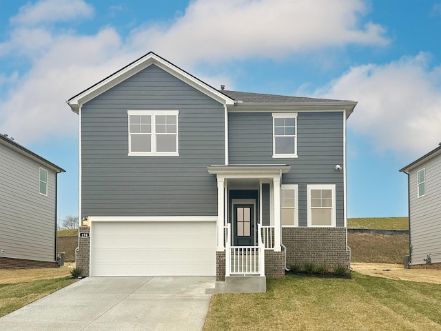 view of front of house with a garage, a front yard, brick siding, and driveway