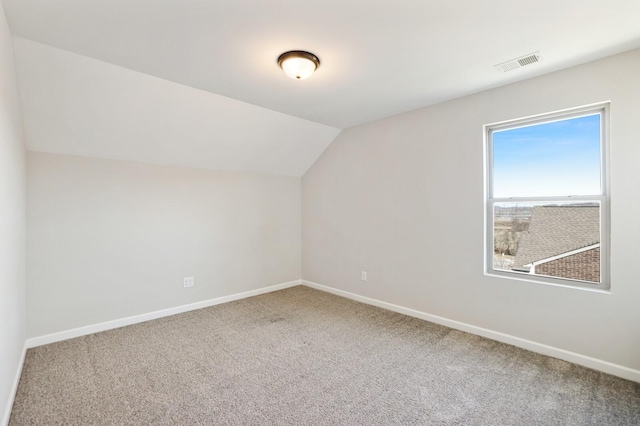 bonus room with carpet floors, visible vents, vaulted ceiling, and baseboards