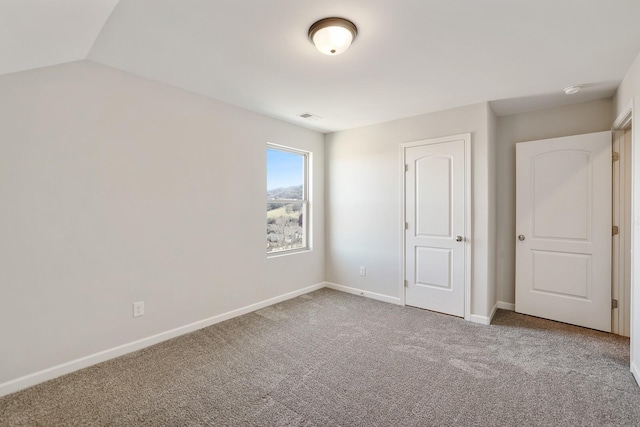 unfurnished bedroom featuring visible vents, baseboards, and carpet flooring