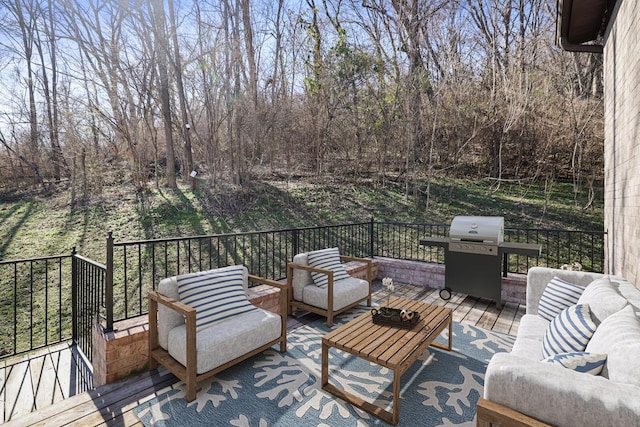 wooden terrace featuring a grill and outdoor lounge area