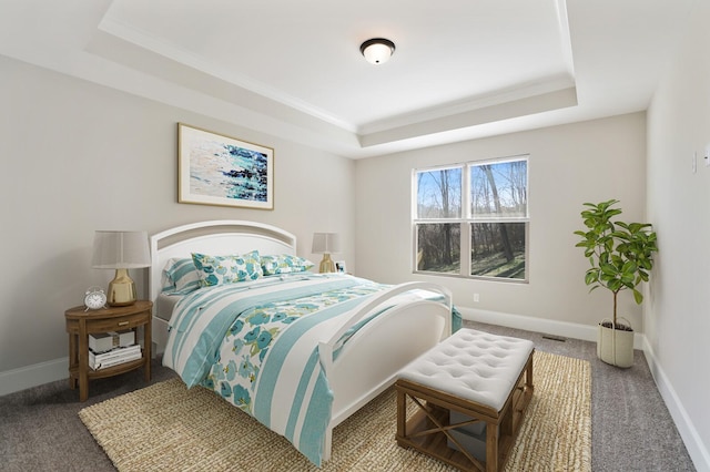 bedroom featuring carpet, baseboards, and a raised ceiling