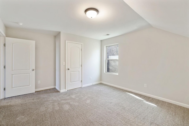 bonus room with carpet floors, lofted ceiling, visible vents, and baseboards