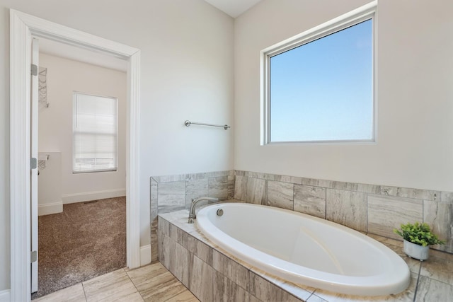 bathroom with a garden tub