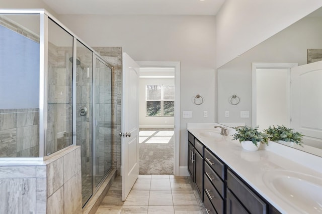 bathroom with double vanity, a sink, and a shower stall