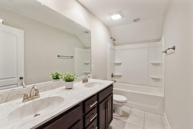 full bathroom featuring double vanity, a sink, toilet, and tile patterned floors