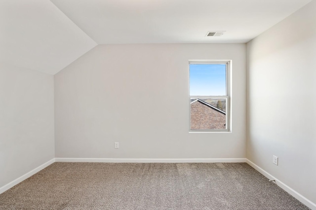 additional living space with carpet, visible vents, lofted ceiling, and baseboards