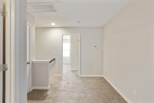 spare room with carpet, visible vents, baseboards, and recessed lighting