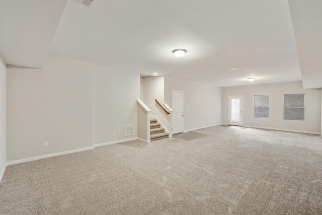 basement featuring carpet, visible vents, baseboards, and stairs