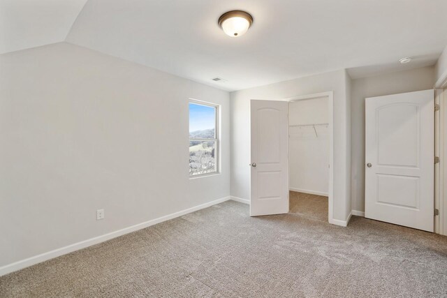 unfurnished bedroom with carpet floors, a closet, visible vents, and baseboards