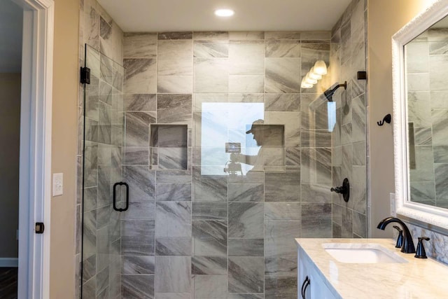 bathroom with a stall shower and vanity