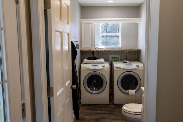 laundry room featuring laundry area, dark wood-type flooring, and washing machine and dryer