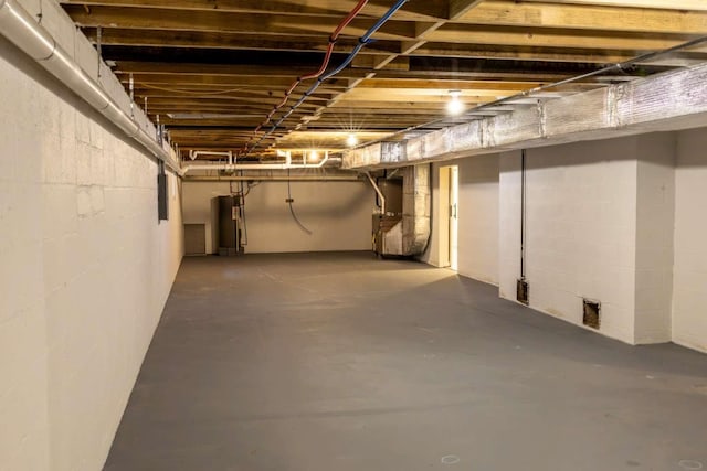 unfinished basement featuring water heater