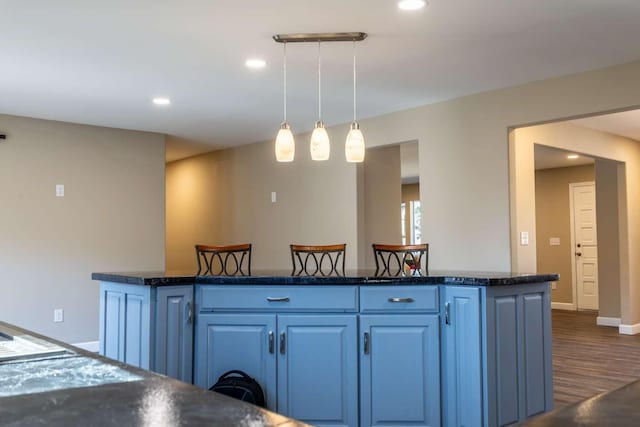 kitchen featuring dark wood-style floors, recessed lighting, decorative light fixtures, and blue cabinets