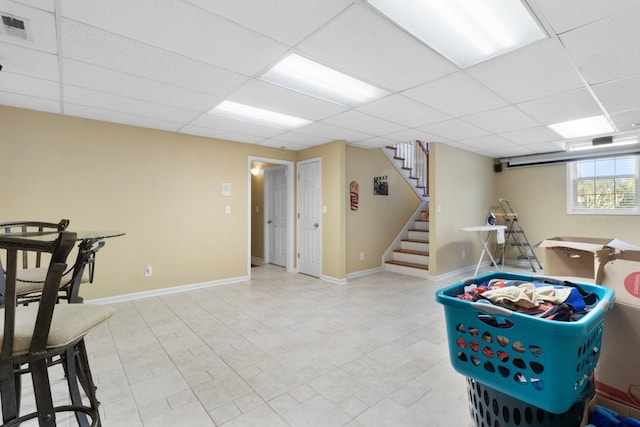 rec room featuring a paneled ceiling, visible vents, and baseboards