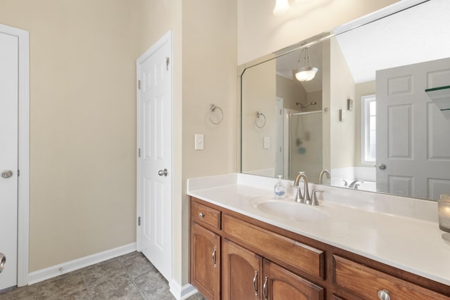 bathroom with a stall shower, tile patterned floors, baseboards, and vanity