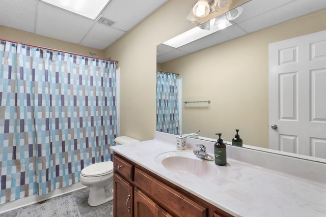 full bathroom with a drop ceiling, toilet, vanity, visible vents, and a shower with curtain