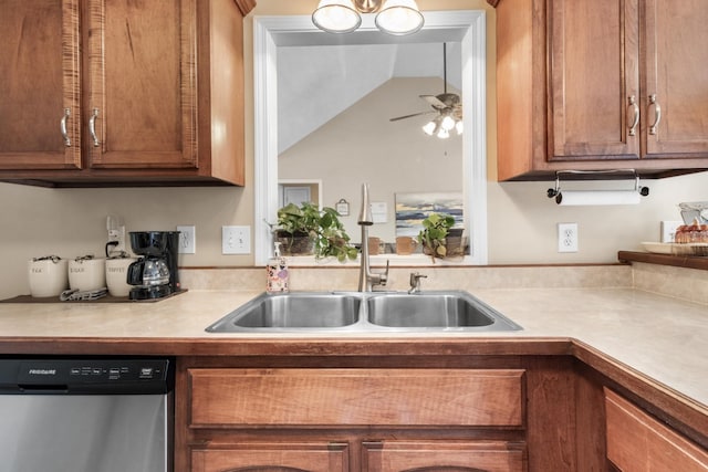 kitchen with a sink, brown cabinets, light countertops, and dishwasher