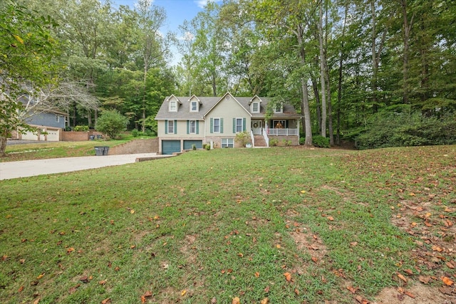 view of front of house with a garage, covered porch, a front lawn, and concrete driveway