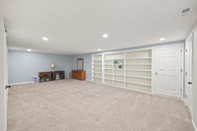 basement with built in shelves, visible vents, carpet flooring, and recessed lighting