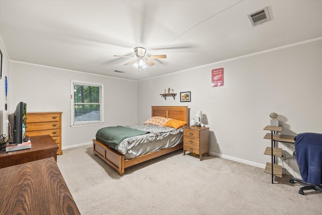 carpeted bedroom with visible vents, crown molding, and baseboards