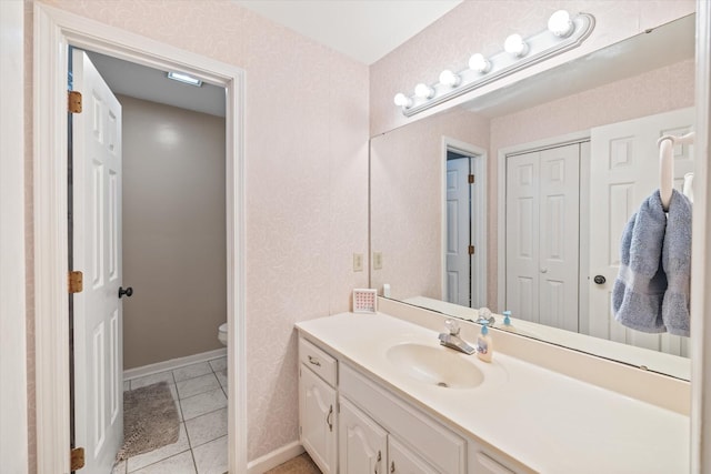 bathroom featuring toilet, tile patterned flooring, vanity, and wallpapered walls