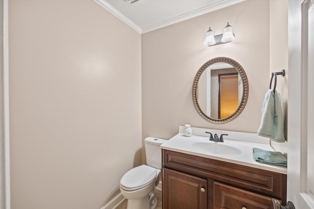 bathroom featuring toilet, crown molding, and vanity